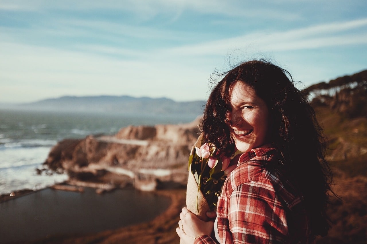 woman smiling on beach - oral probiotics