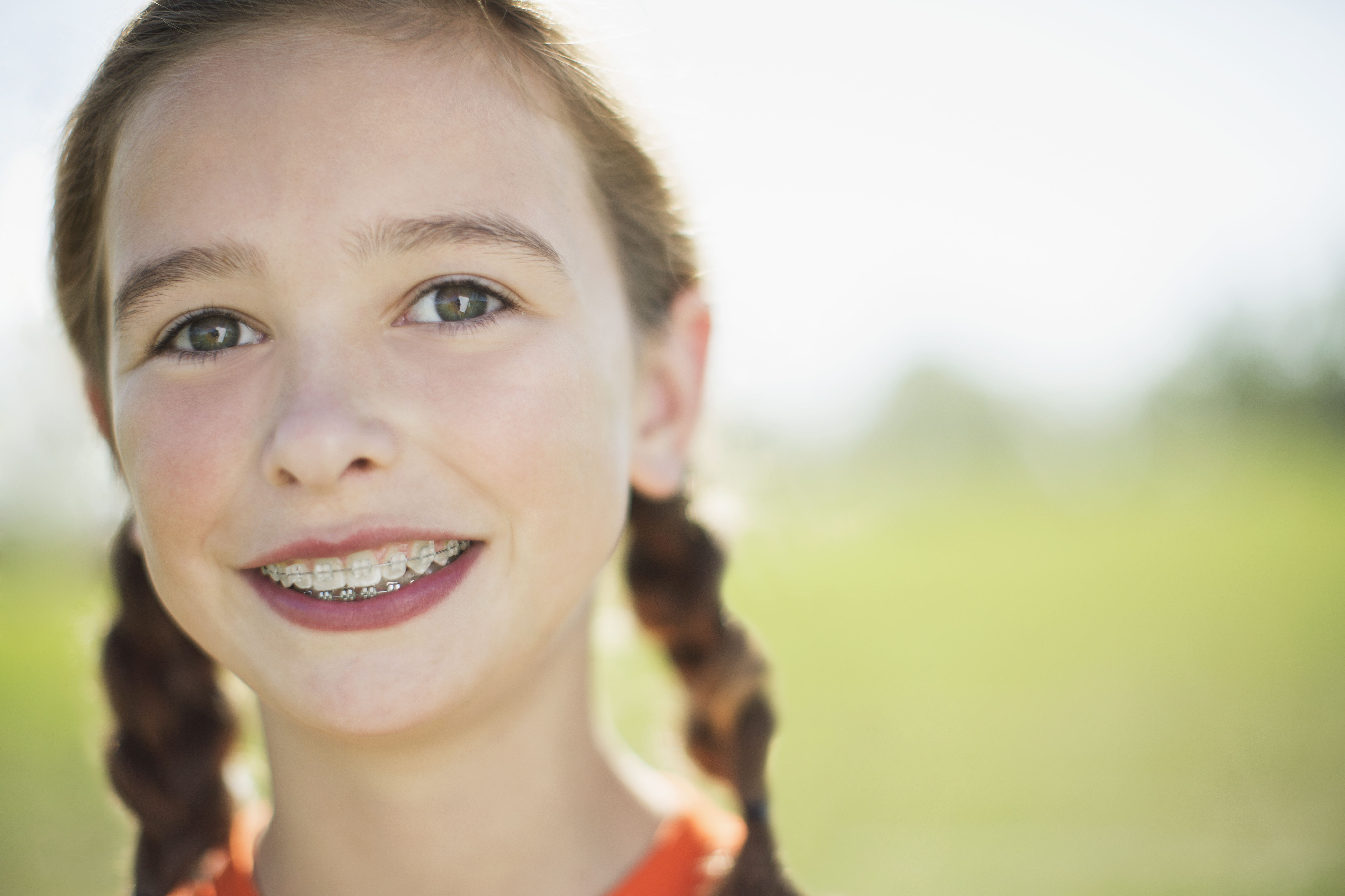 how to use a waterpik - Portrait of female soccer player with pigtails and braces.