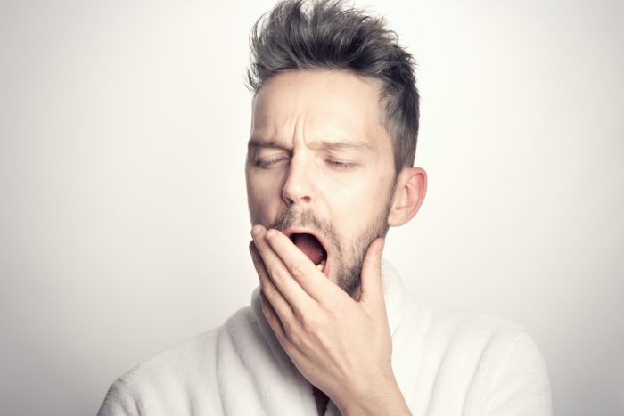 does TMJ cause tooth pain - man holding jaw