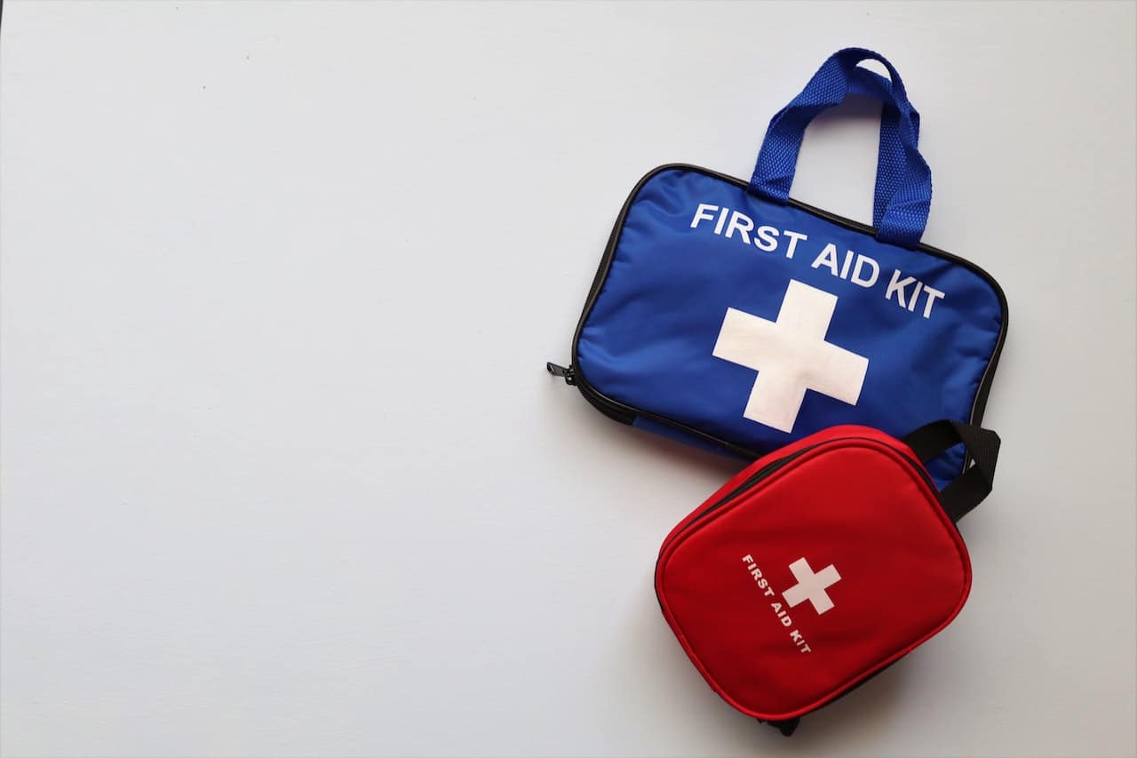 blue and red first aid kits on white background