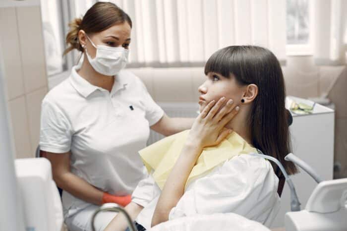 woman in dentist office with toothache